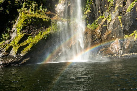 Double rainbow beneath a waterfall in Milford Sound