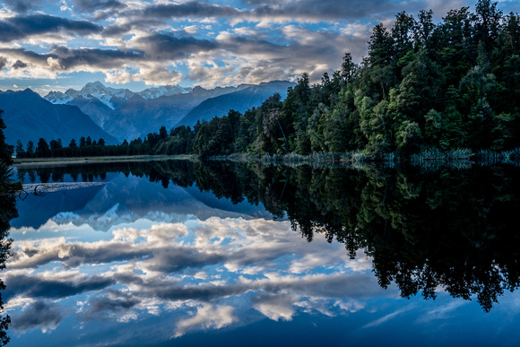 Lake Matheson  with the Southern Alps reflected in the lake's usual calm water